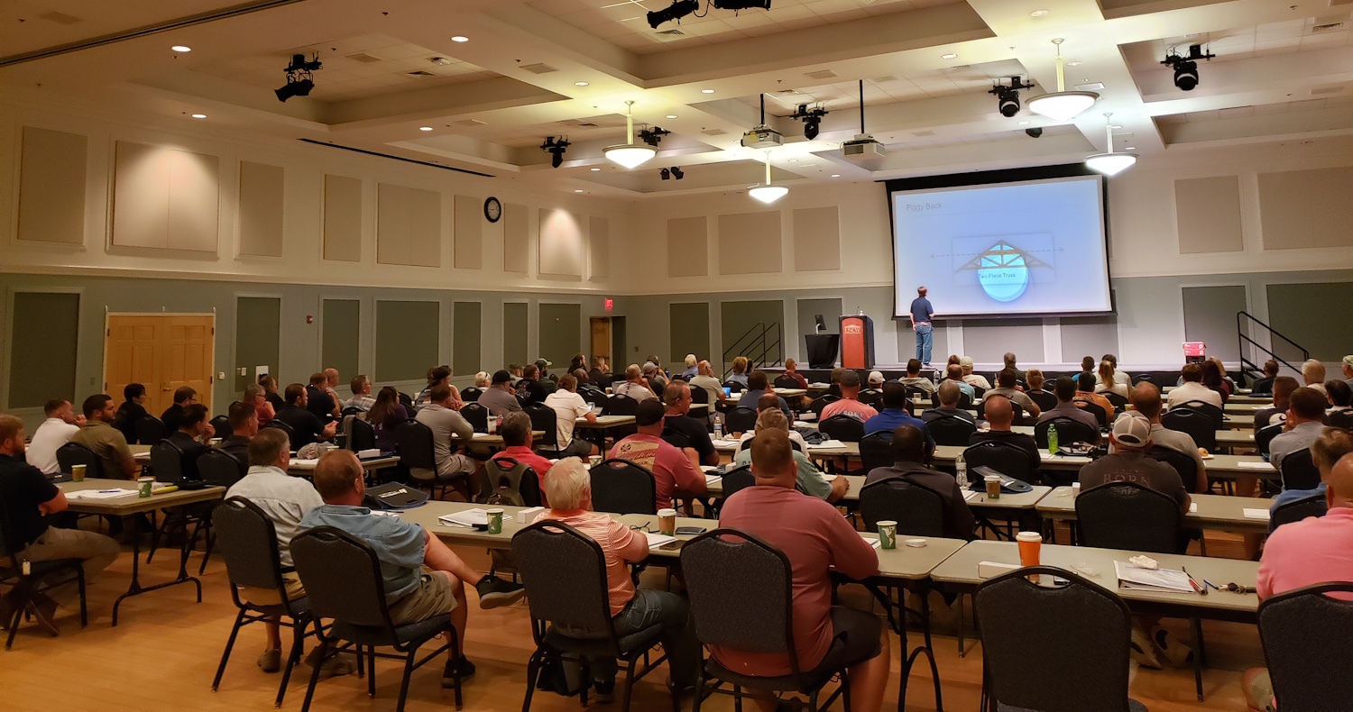 Students writing notes during regional traveling seminar conference lecture